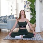 몸과 마음을 위한 대체요법, 일상에 자연스럽게 녹이다 a woman sitting on a yoga mat in a living room