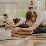 현대인의 건강한 일상, 필라테스에서 찾다 a group of people doing yoga in a room
