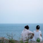 정신건강, 일상 속 작은 변화를 통한 회복의 시작 two people sitting on a rock looking out at the ocean