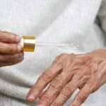 저속노화, 일상에서 젊음을 유지하는 비결 an older woman holding a small tube of liquid